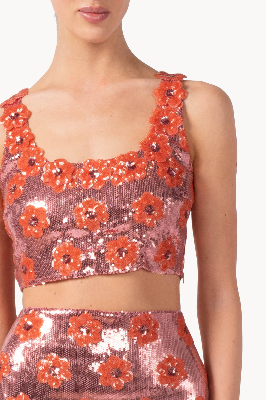 Top rosa con margherita e paillettes