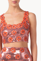 Top rosa con margherita e paillettes