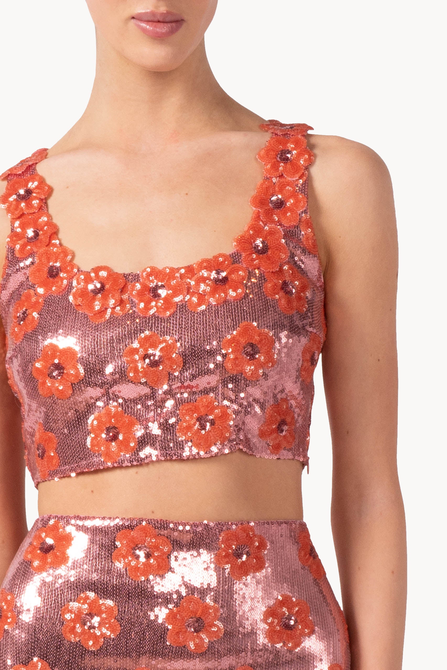 Top rosa con margherita e paillettes