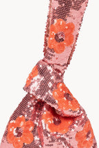 Clutch rosa con margherita e paillettes da portare a mano